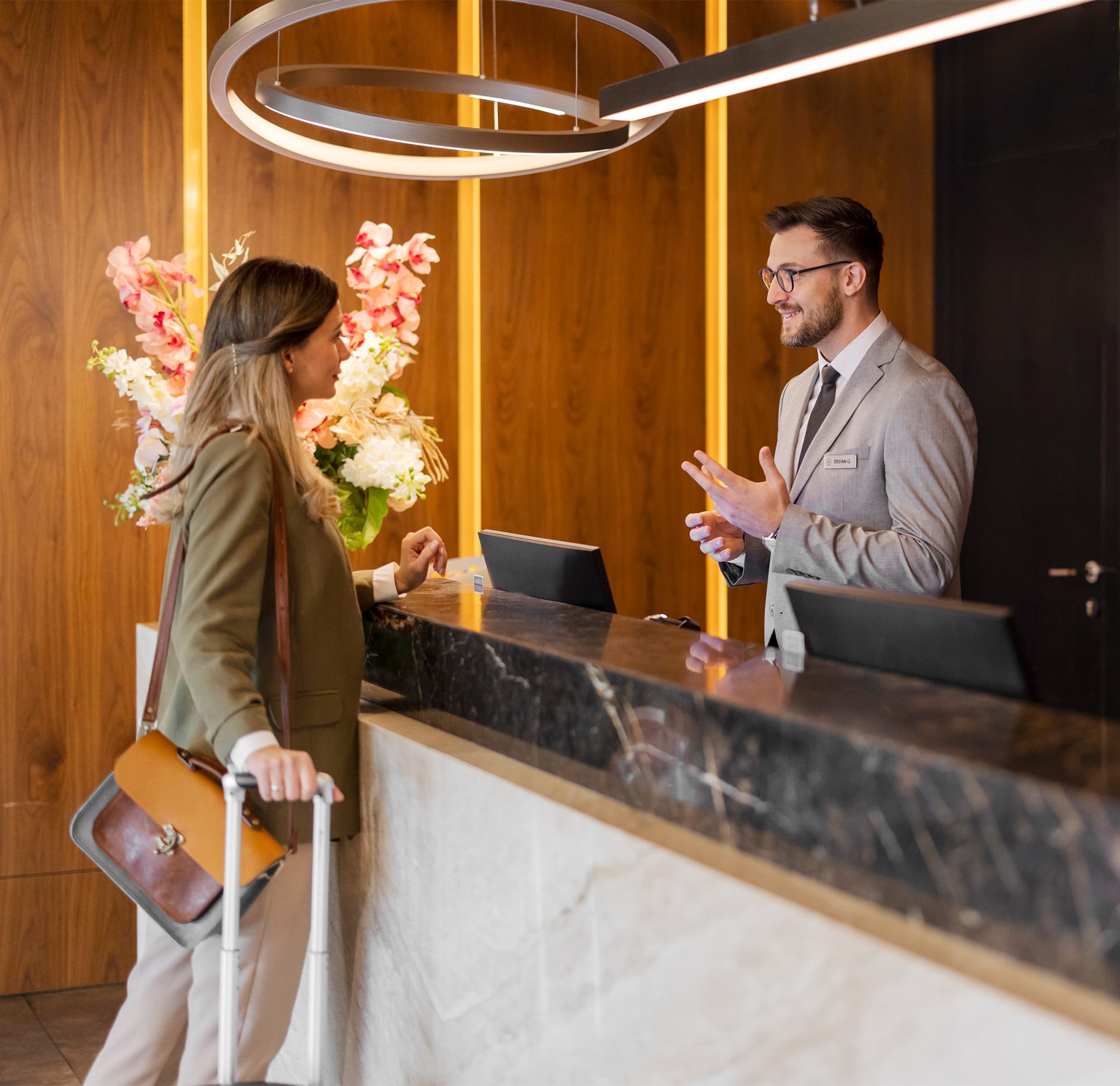 A guest arriving at a five-star hotel reception desk.