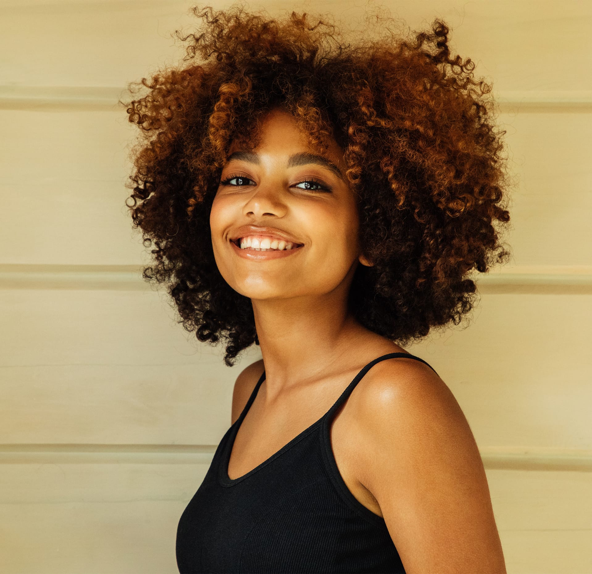 Woman with curly hair smiling