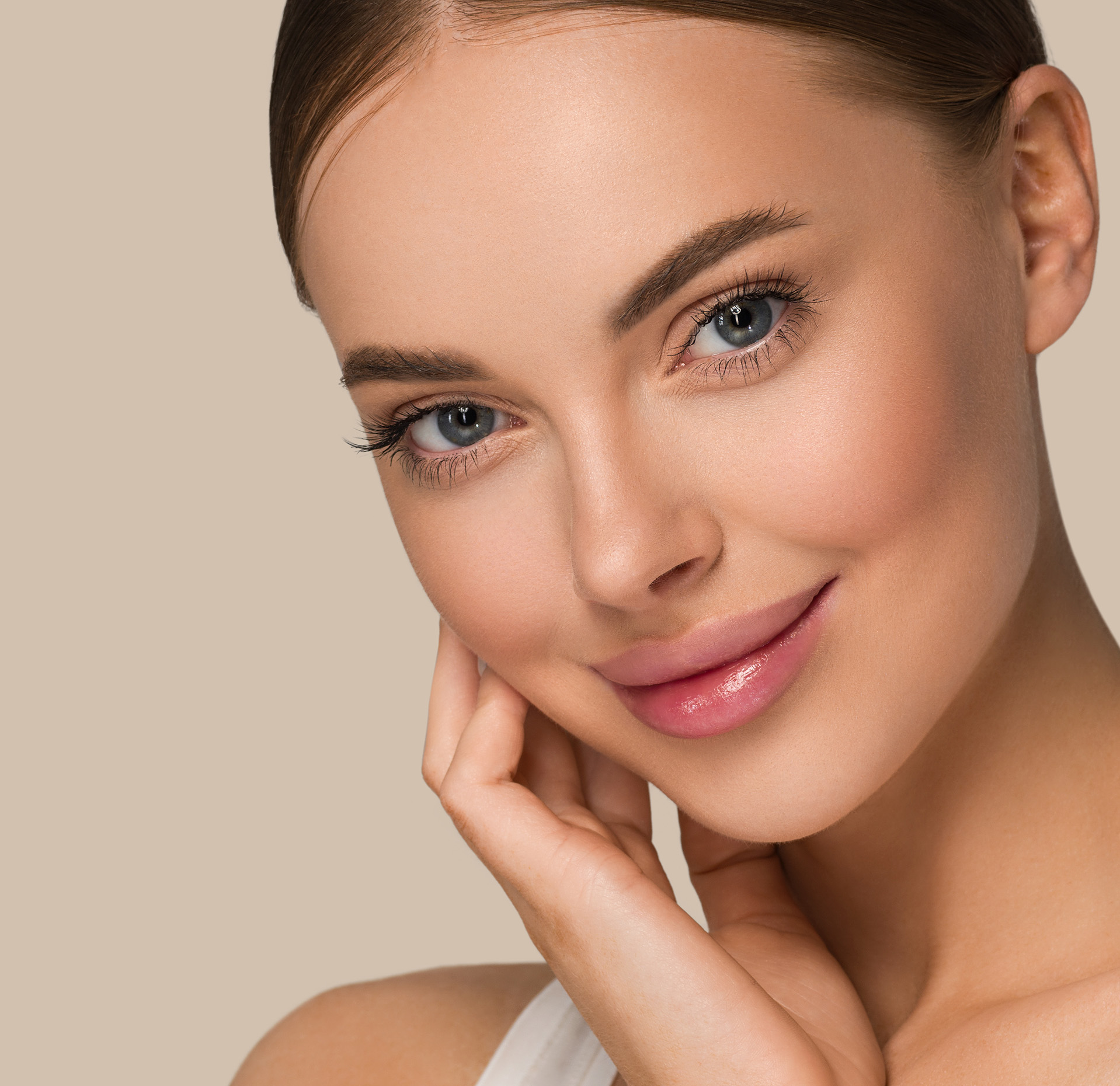 Woman smiling with her hand on her cheek